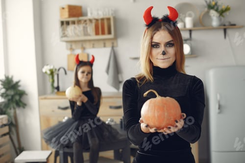 Preview: Mother with daughter in a halloween costume and makeup
