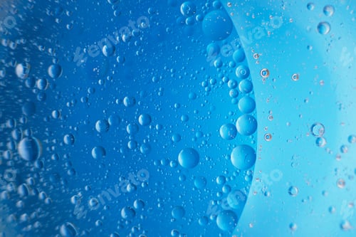 Preview: abstract light blue background with oil circles . bubbles of water close up .