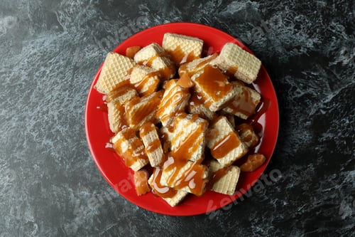 Preview: Plate with wafers with caramel on black smokey table