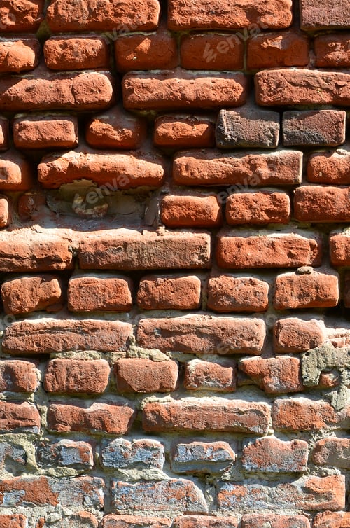 Preview: Vertical wall texture of several rows of very old brickwork made of red brick