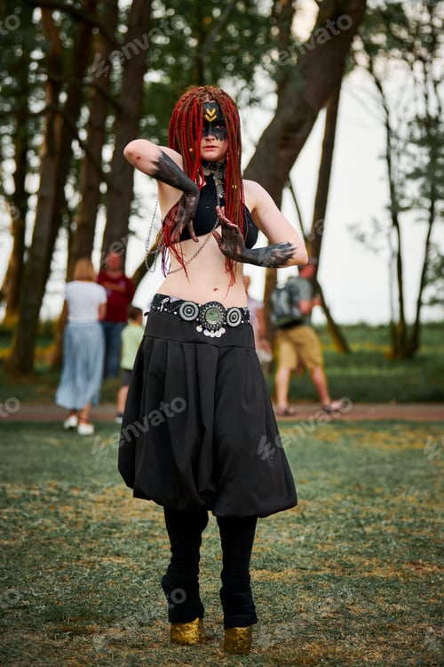 Preview: Mythological dancing girl faun on green lawn in public park outdoor art dancing event