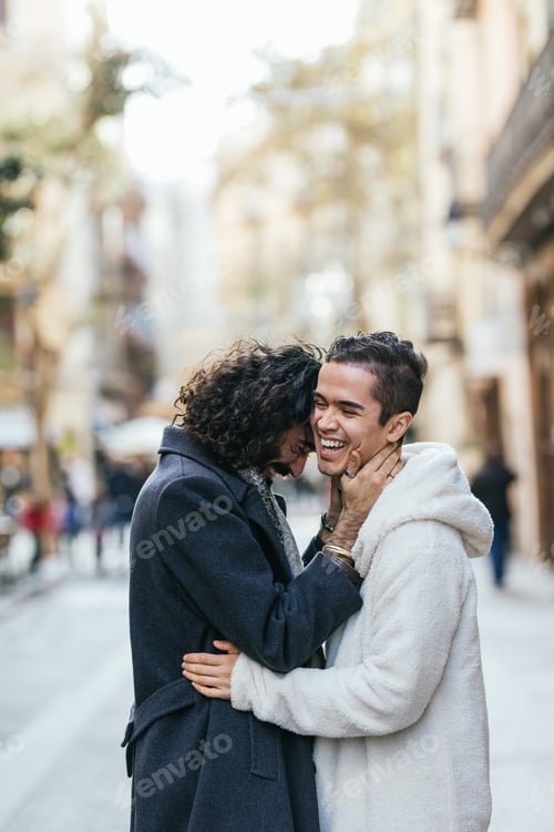 Preview: Happy gay couple embracing on city street