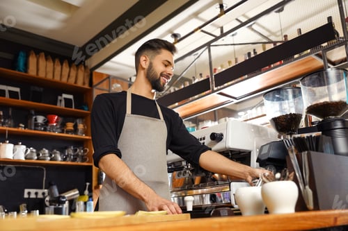 Preview: Smiling barista near coffee machine in cafe, low angle view