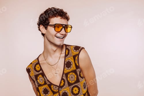 Preview: Happy smiling gay man with sunglasses at studio