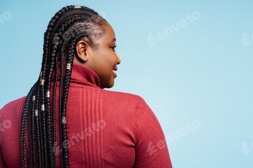 Preview: Back view smiling African American woman with stylish braided hair looking away. Hair salon
