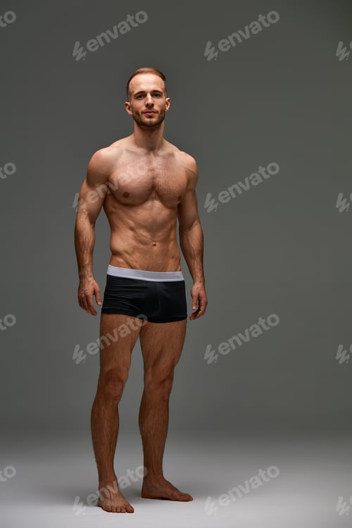 Preview: Young male athlete posing. Handsome athletic male power guy. Fitness muscular person. Young athlete
