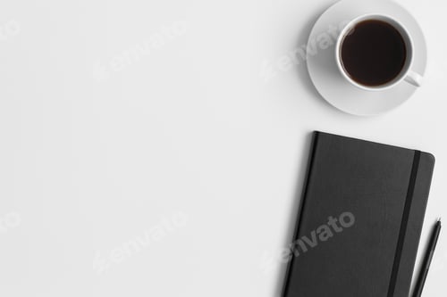 Preview: Black Coffee, Notebook, and Pen on White Background