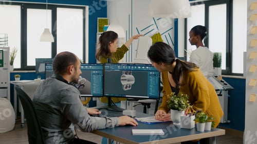 Preview: Team of engineers talking in front on pc with CAD software