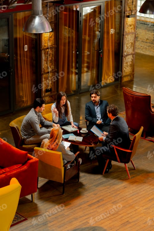 Preview: top shot in large beautiful hall office employees sitting on yellow chairs discuss a deal