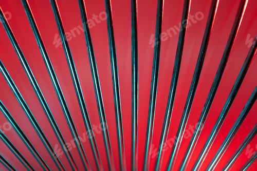 Preview: Closeup of coiled metal spring with sufficiently high strength and elastic properties in neon light