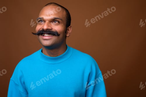 Preview: Face of happy Indian man with mustache wearing blue sweater