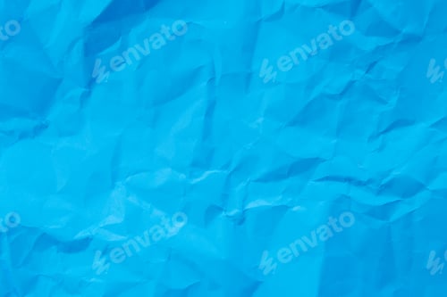 Visualização: Uma foto em close-up, de cima para baixo, revela a superfície texturizada de papel azul claro amassado.