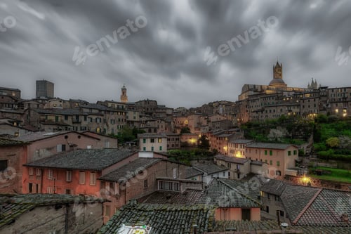 Preview: Beautiful shot of a stormy dark sky over a historic cityscape in Siena, Italy