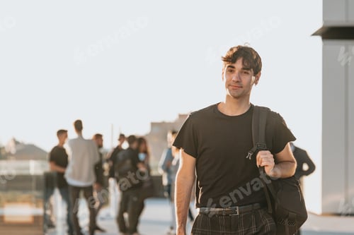 Preview: Young man college student walking with bag smiling happy. Student in high school