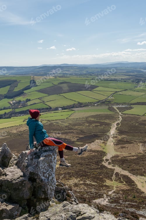 Preview: High angle shot of a hiker enjoying the view from the Sugar Loaf Mountain Viewpoint in Ireland