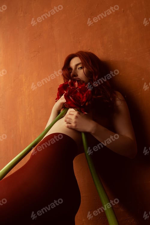 Preview: Beautiful Girl With Red Hair, Makeup And Styling. Red Flowers In The Hands