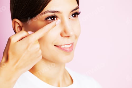 Preview: Pretty young woman puts on contact lenses for eyesight