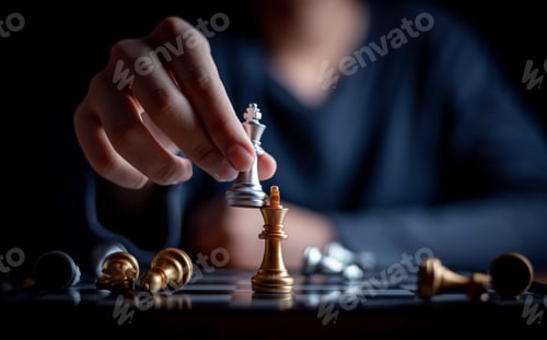 Preview: Young boy playing chess board between golden team and silver team ,he thinking serious how to winner