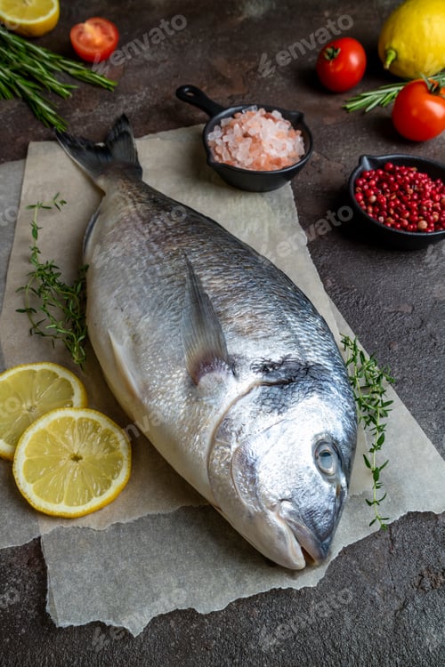 Preview: Fresh fish dorado and ingredients for cooking. Raw fish dorado with aromatic spices