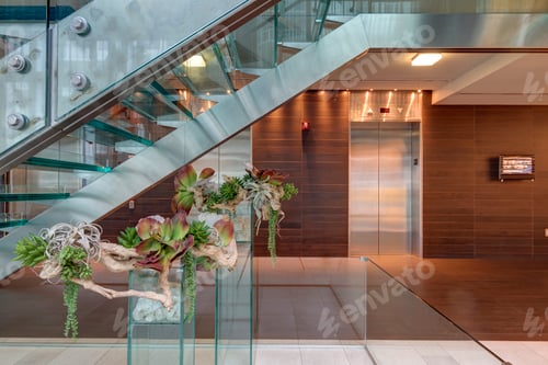 Preview: Glass staircase and elevators in hotel lobby