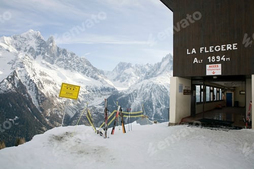 Preview: Skis and sign near mountains