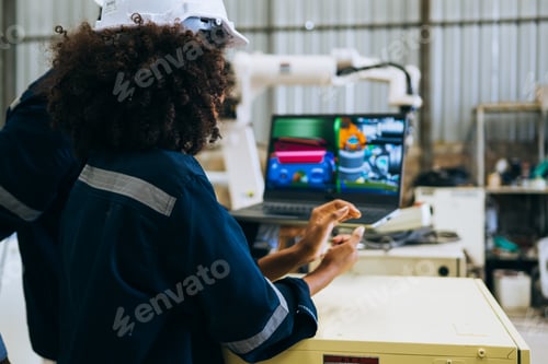 Preview: Engineer technician controlling robotic arms on computer laptop