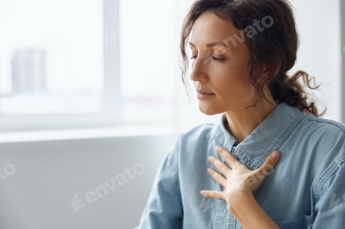 Preview: Serious irritated anxious angry curly-haired businesswoman is trying to calm down doing breathing