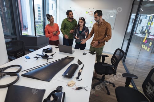 Preview: Diverse group of creative colleagues discussing work and brainstorming at meeting