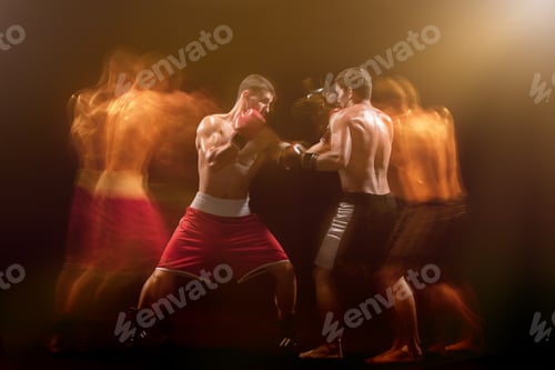 Preview: The two male boxers boxing in a dark studio