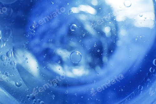 Preview: Oil bubbles close up. circles of water macro. abstract light blue background
