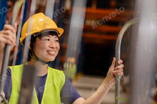 Preview: Smiling Asian Female Warehouse Worker in Safety Gear