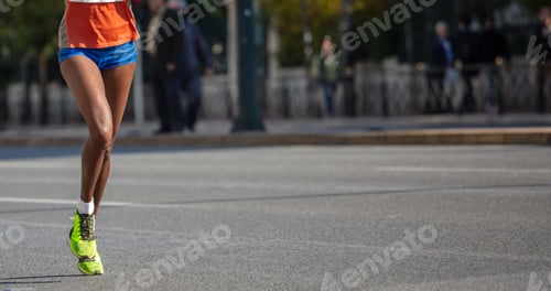 Preview: Running in the city roads. Young woman runner, front view, banner, blur background