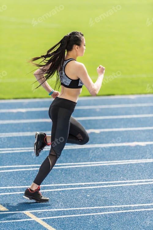 Preview: asian sportswoman training on running track stadium, young girl running concept