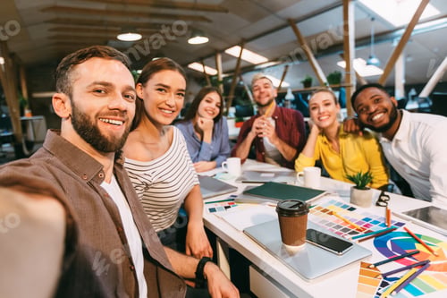 Preview: Happy designers making selfie at workplace, working on project