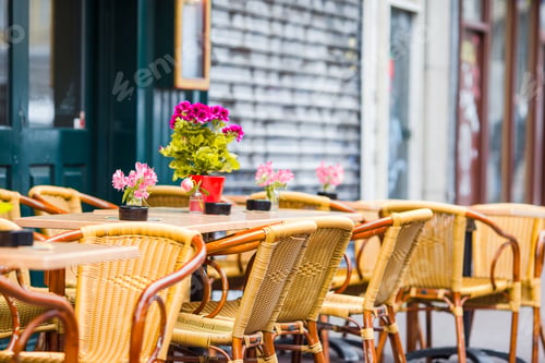 Preview: Outdoor cafe on a street of typical greek traditional village in Greece. Coffee on table for