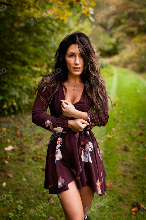 Preview: Long haired mid adult woman wearing short dress looking at camera seductively