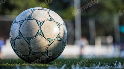 Preview: Football soccer ball on the field, isolated, with copy space in blurry background, wallpaper.