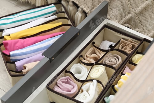 Preview: Organizers with folded clothes in drawer indoors, closeup