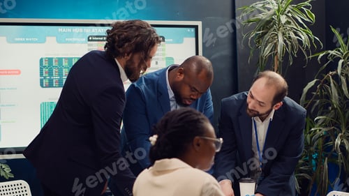 Preview: Business associates reviewing latest financial plans on documents