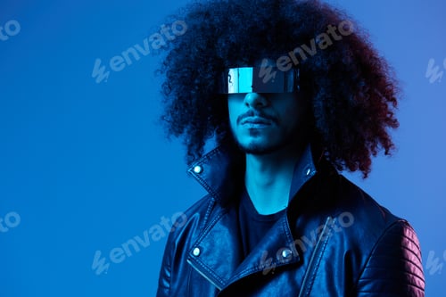 Preview: Portrait of fashion man with curly hair with stylish glasses on blue background multinational
