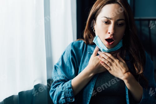 Preview: scared woman with open mouth in medical mask touching throat