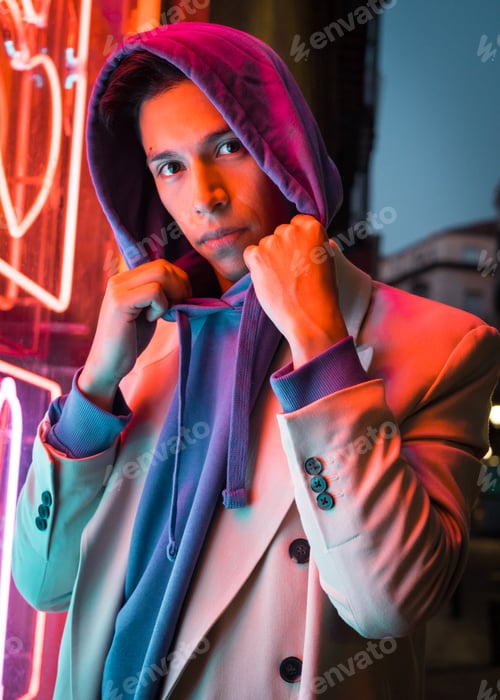 Preview: Young millennial hispanic man with red neon light reflection