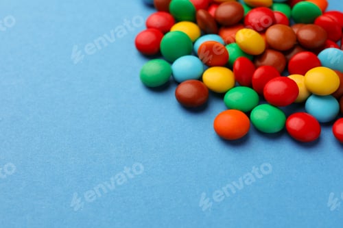 Preview: Tasty colorful candies on blue background, space for text