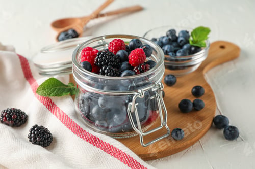 Preview: Kitchen accessories and berries on white cement background, space for text