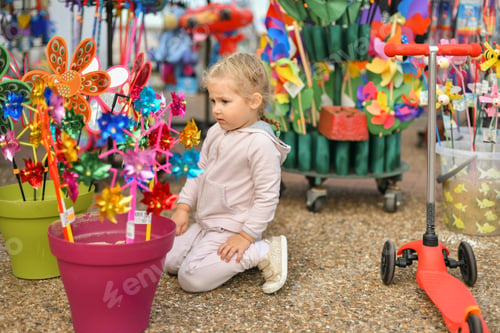Preview: Girl looks at the windmills in the store