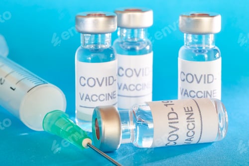Preview: Covid-19 Vaccine and Syringe on a Blue Background