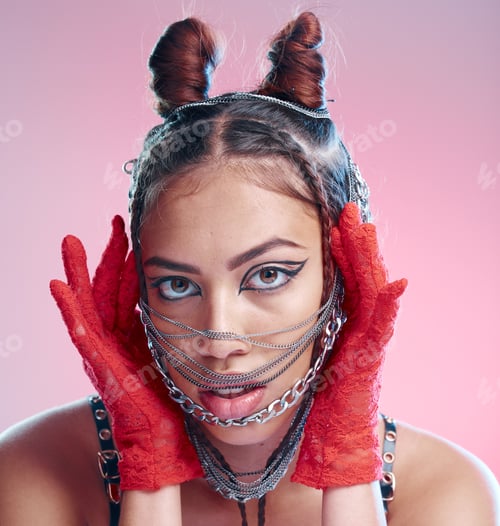 Preview: Stylish, goth and portrait of a woman with chains on her face on a pink studio background. Face, he