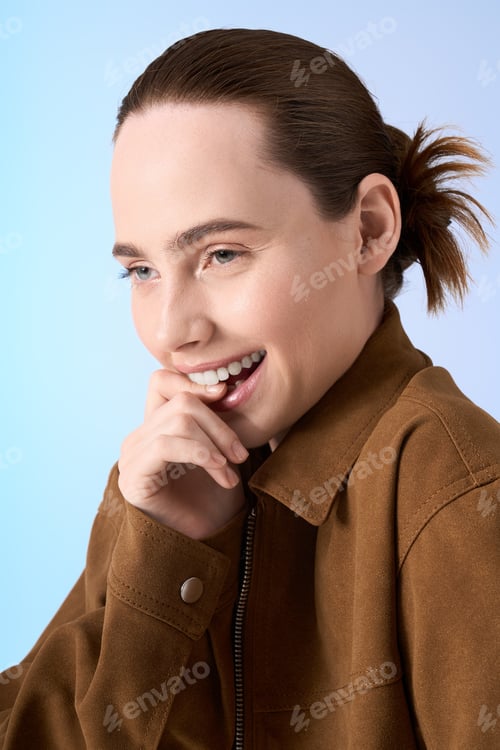 Preview: Young woman with a stylish smile captures joy in a minimalist setting