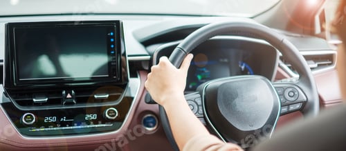 Preview: woman driver driving a car on the road, hand controlling steering wheel