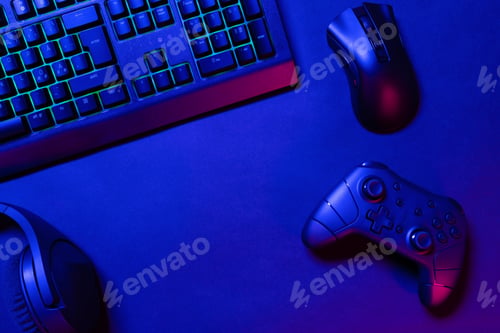 Preview: Green lit keyboard on blue lighted gaming gadgets on desk